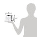 A person holding a Hamilton Beach clear glass coffee carafe with a black handle.