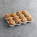 A tray of David's Cookies Blueberry Crumb Muffins on a gray surface.