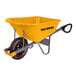 A yellow True Temper wheelbarrow with black handles.