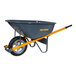 A grey True Temper wheelbarrow with yellow handles.