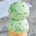 Two scoops of Klein's Real Kosher Vegan Mint Chip Ice Cream in a cone.
