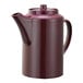 A burgundy plastic teapot with a lid.