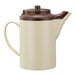 A white and brown stoneware teapot with lid.