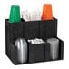 A black Dispense-Rite countertop organizer with cups and lids in it.