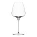 A clear Stolzle Cocoon burgundy wine glass with a long stem and a curved bottom with a white rim.