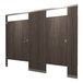A Hadrian bathroom partition with brown wood doors and silver trim.