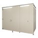 A Hadrian bathroom stall partition with two white doors and silver handles.