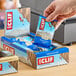 A hand holding a blue and white package of Clif Bar Chocolate Chip Energy Bars.