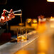 A person pouring whiskey into a Stolzle Kyoto old fashioned glass.