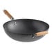 A 14-inch carbon steel non-stick flat bottom wok with wooden handles.