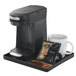 A Hamilton Beach coffee maker tray with a cup of coffee on it.