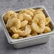 A square container filled with lemon pepper breaded shrimp.
