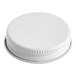 A white metal lid with a white plastic cap on it.