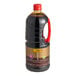 A black plastic container of Lee Kum Kee Premium Dark Soy Sauce with a red lid.