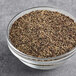 A bowl of McCormick Culinary Table Grind Black Pepper on a table.