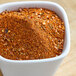 A white bowl of McCormick Harissa seasoning.