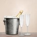 A Posh Setting plastic champagne flute filled with ice and two empty flutes.