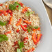 A white plate with rice, peppers, and vegetables on it.
