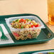 A tray of food with a Dart clear plastic container of pasta and vegetables.