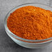 A bowl of orange powdered McCormick Culinary Vietnamese Cajun Seasoning.