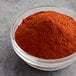 A bowl of McCormick Extra Fancy Paprika powder.