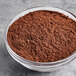 A bowl of brown McCormick Culinary Ground Allspice.