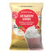 A white bag of Big Train Strawberry Banana Blended Creme Frappe Mix with a label.