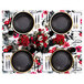 A Posh Setting black plastic plate with gold trim on a table with more plates and silverware.