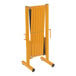 A yellow and black Vestil Expand-A-Gate folding security gate with wheels.