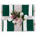 A table set with Posh Setting green plastic charger plates and white place mats with a bouquet of flowers.