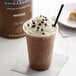 A close-up of a Ghirardelli Mocha Frappe with whipped cream and chocolate chips.