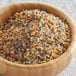 A wooden bowl filled with McCormick Grill Mates Montreal Steak Seasoning.