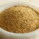 A bowl filled with McCormick Grill Mates Montreal Chicken Seasoning on a wooden table.