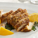 A plate of food with McCormick Montreal Chicken Seasoning, lemon slices, and herbs.