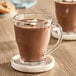 A glass cup of Ghirardelli hot chocolate with marshmallows on top.