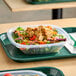 A salad in a Dart clear polypropylene bowl on a table.