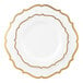 A white plastic plate with gold scalloped bands around the rim.