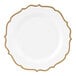 A white plastic plate with gold scalloped bands.