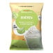 A white and green bag of Big Train Dragonfly Honeydew Blended Creme Frappe Mix with text and a picture of a drink.