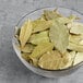 A bowl of McCormick Culinary Bay Leaves on a table.