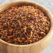 A wooden bowl filled with McCormick Grill Mates Hamburger Seasoning on a marble surface.