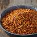 A bowl of McCormick Grill Mates BBQ seasoning on a wood surface.