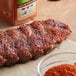 A piece of meat on a cutting board with Cattlemen's Chili Lime BBQ Rub on a table.