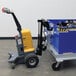 A yellow and grey machine on a blue cart.