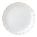 A close up of a Posh Setting white plastic plate with gold trim on the rim.