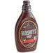 A case of 12 Hershey's Special Dark Chocolate Syrup bottles on a convenience store counter.