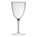 A close-up of a Posh Setting clear plastic wine goblet with a long clear stem.