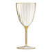 A clear plastic wine goblet with gold glitter on it.