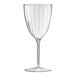 A close-up of a Posh Setting plastic wine goblet with clear liquid and small specks on it.