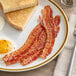 A plate with Daily's precooked bacon, eggs, and toast on it.